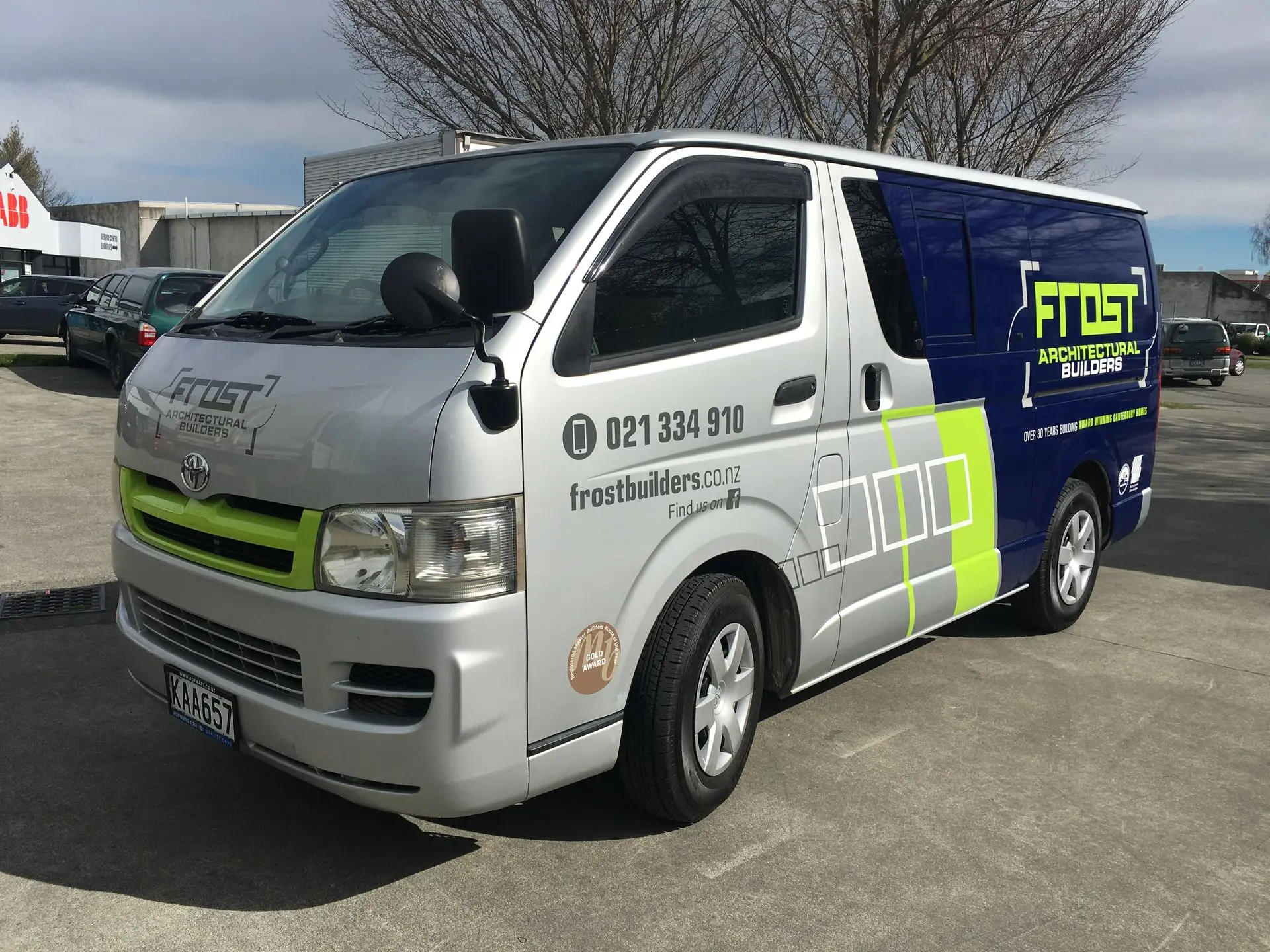 Branded wrap on a construction van for Frost Builders, featuring contact details, brand graphics and frost builders logo.