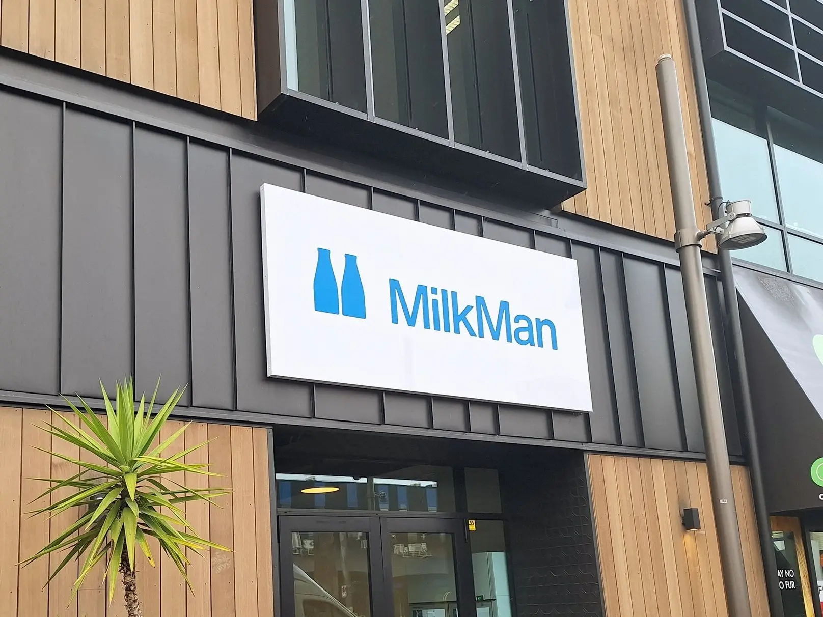 A backlit, illuminated custom brand sign for local Christchurch Coffee shop Milkman