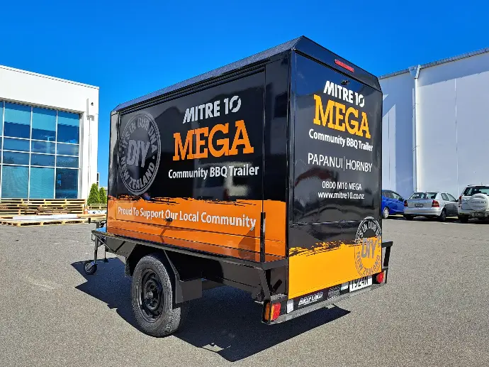 Full coverage branding trailer wrap on a mitre 10 mega hire trailer