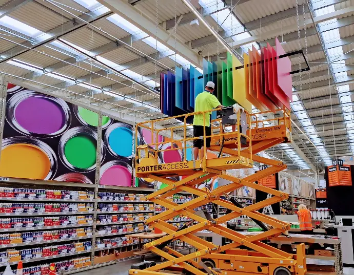 Our experienced team can install custom signage features in-store, such as this hanging paint colour feature in Mitre 10 Mega.