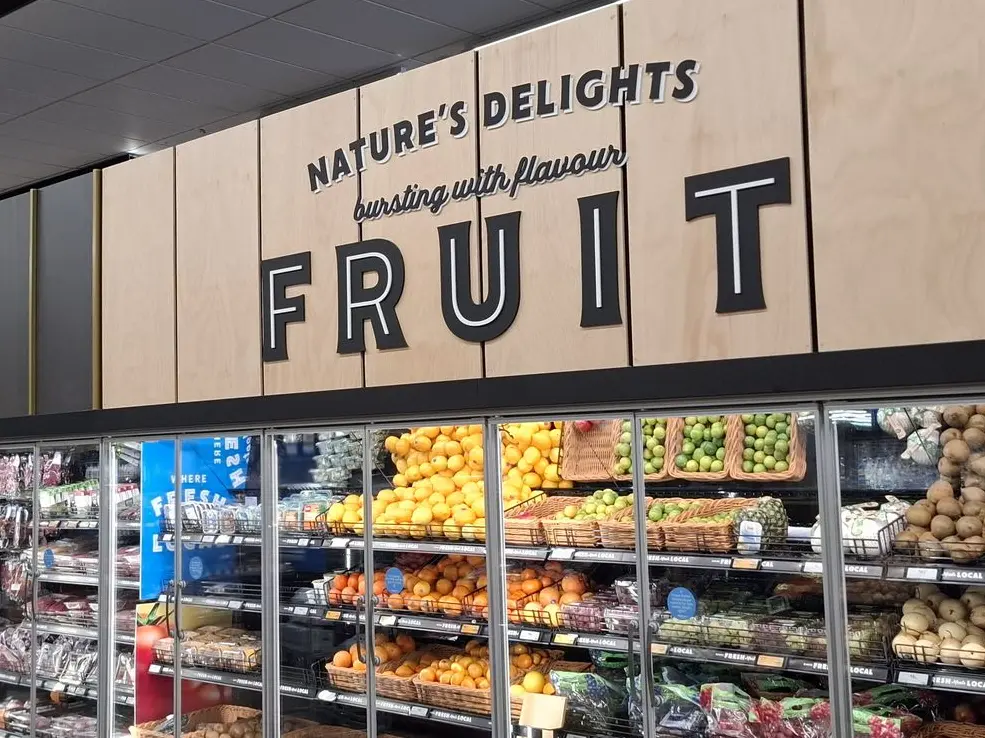 Bulkhead signage for supermarkets helps customers find products, like this Fruit signage at Fresh Choice