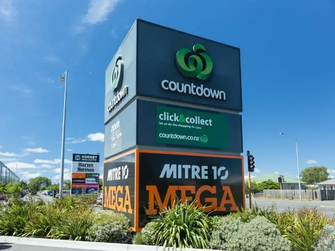 Large scale commercial pylon showcasing multiple businesses and supermarkets.