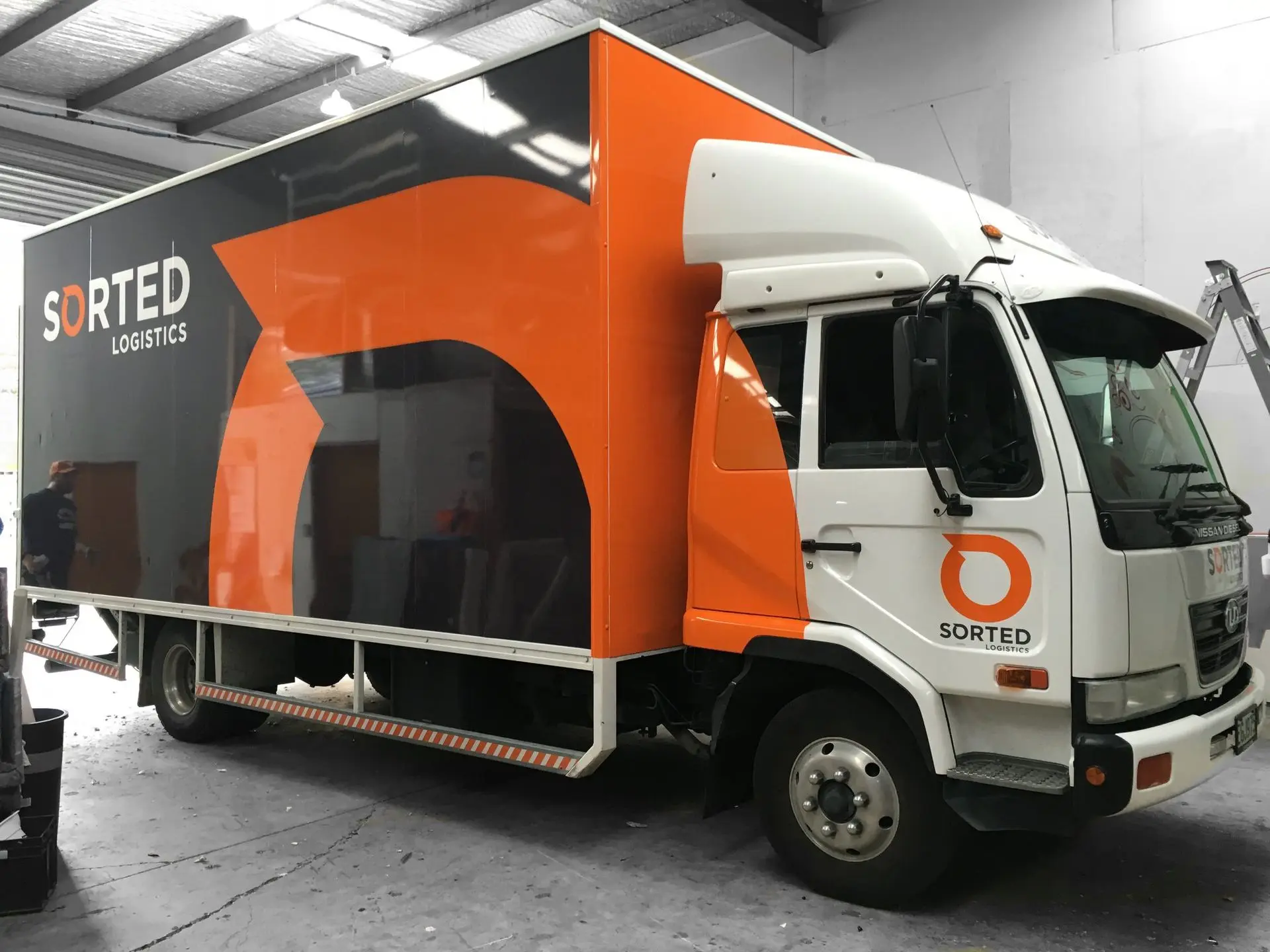 Full-scale cab and storage wraps on a logistics transport vehicle