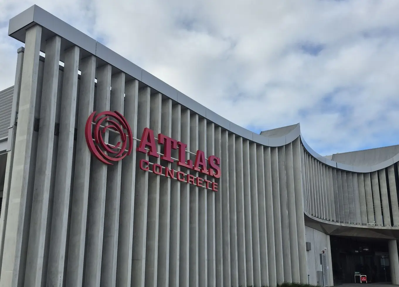 Custom Logo Illuminated logo sign, mounted on vertical concrete beams for Atlas Concrete.