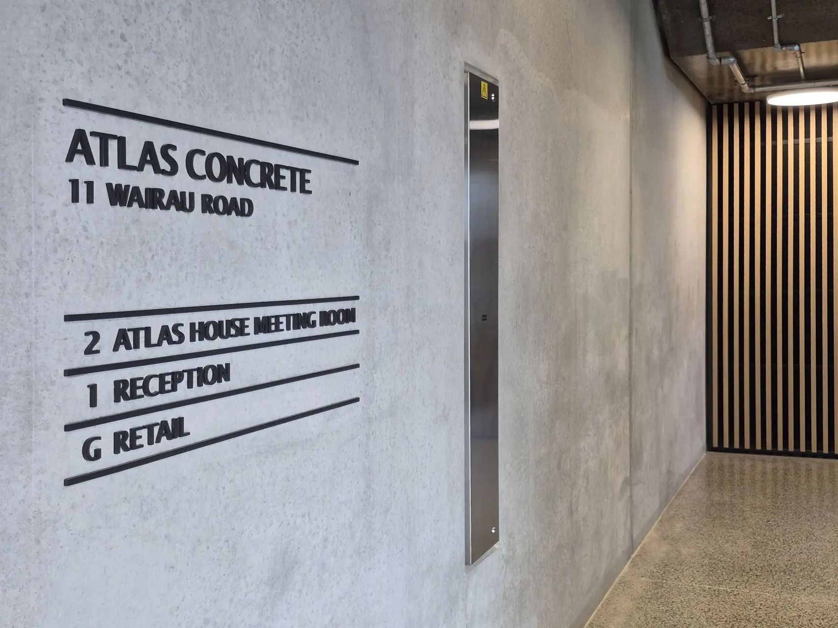 Custom laser cut lettering signage for reception area at Atlas Concrete by Displayworks