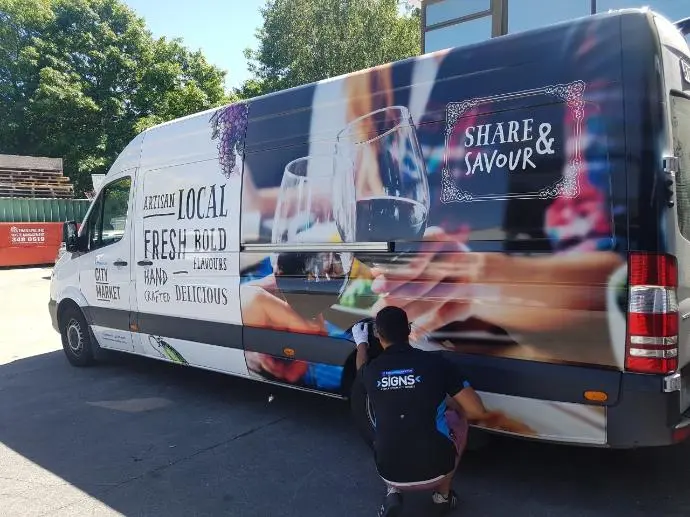 Displayworks sign writer add finishing touches to hospitality delivery van signage