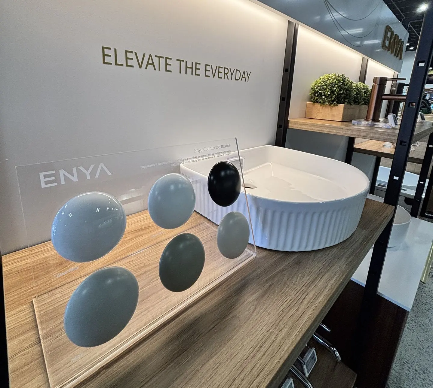 A custom acrylic stand designed and fabricated for an Enya bathroom display by Displayworks for Harrion Bloy Christchurch