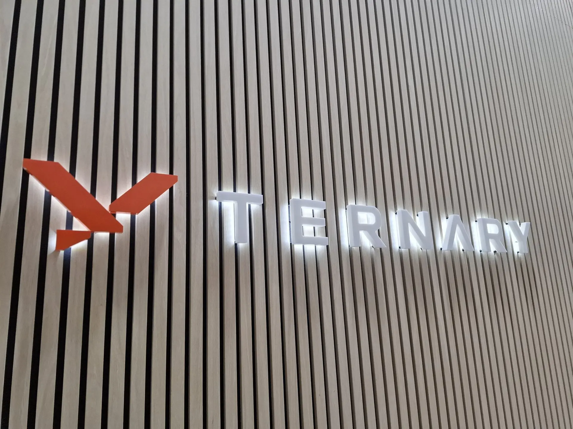 A custom illuminated halo logo sign for Tenary, by Displayworks