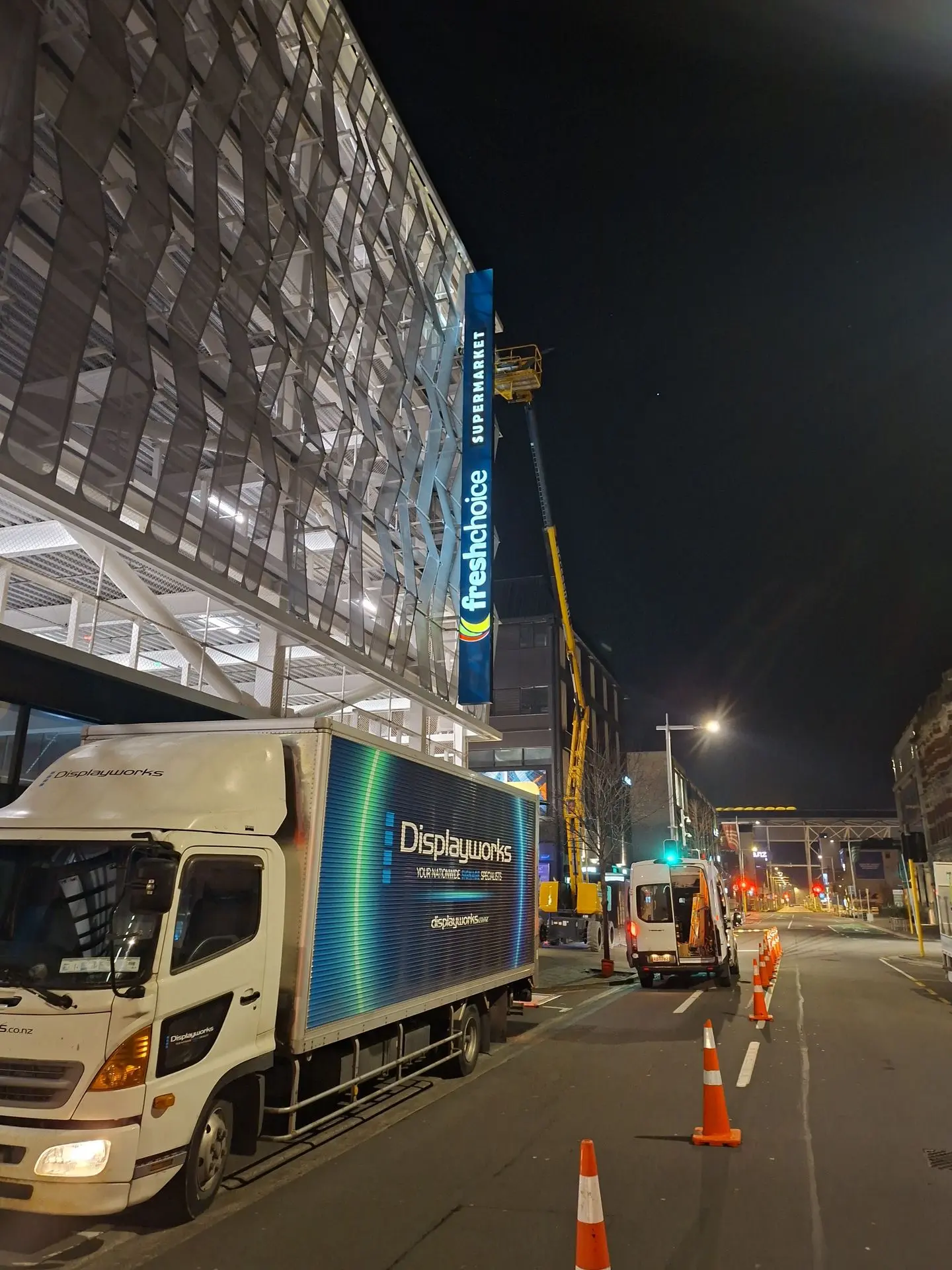 New illuminated signage for Fresh Choice installed on The Crossing parking building in central Christhurch